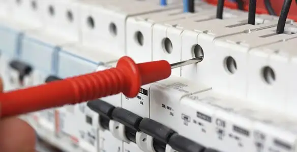 Electrical contractor testing circuit breakers during electrical repair in Hooper, UT