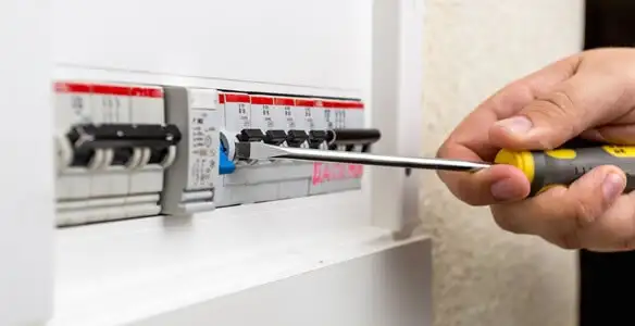 electrical panel upgrade service showing technician adjusting circuit breakers during system upgrade in Ogden, UT