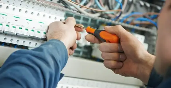 electrical service showing licensed electrician performing electrical panel maintenance and adjustments in Ogden, UT