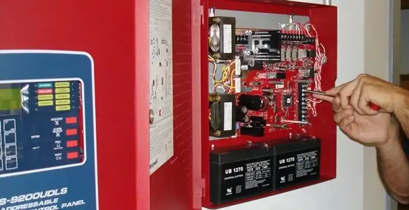 fire alarm installation service showing technician configuring fire alarm control panel in Ogden, UT