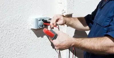 Electrician performing home electrical outlet and wiring inspection in Ogden, UT