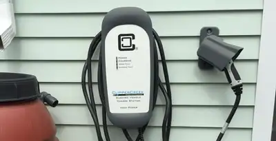 Outdoor electric vehicle charger installation on residential wall in Ogden, UT