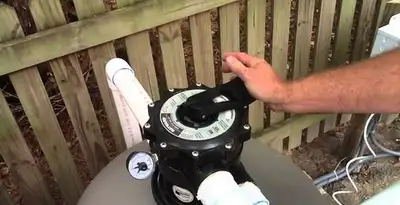 pool pumps service showing professional adjustment of pool pump control system in Ogden, UT