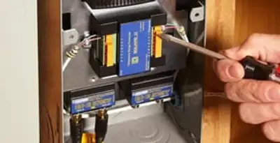 Whole home surge protection device being installed by a licensed electrician to protect electrical systems in Ogden, UT